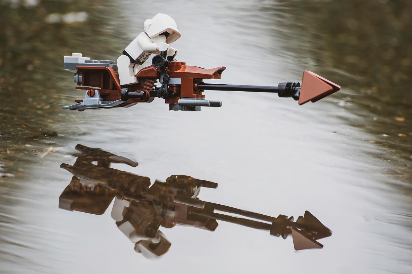 Lego speeder cruising over water